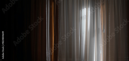 The window in the room is covered with blinds and curtains