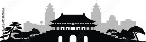 Historic korean style gate silhouette with traditional tiered roof and surrounding pine trees