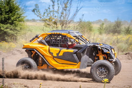 UTV buggy moves on dusty road. 4x4, extreme, adrenalin.