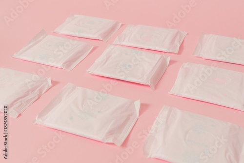 Flat layout of sanitary napkins on pink background. Menstruation cycle, feminine hygiene and protection