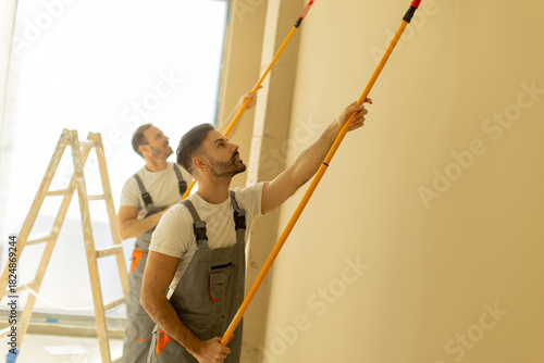 Workers apply fresh paint o...