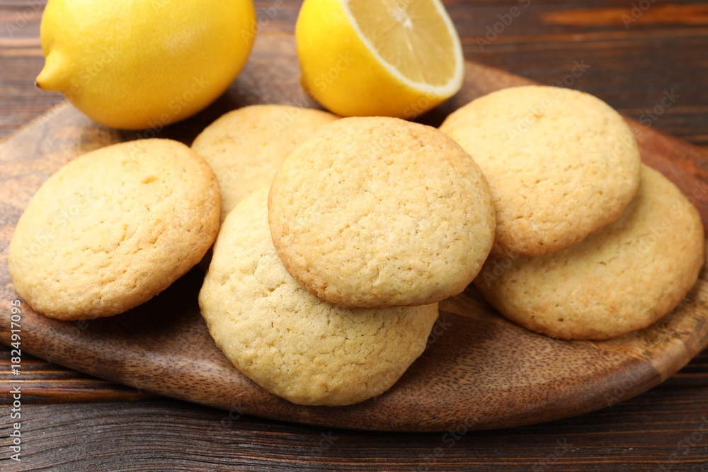 Fototapeta premium Tasty lemon cookies and fruits on wooden table, closeup