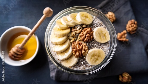 moody top view of overnight oats topped with bananas walnuts chia seeds and drizzle of honey