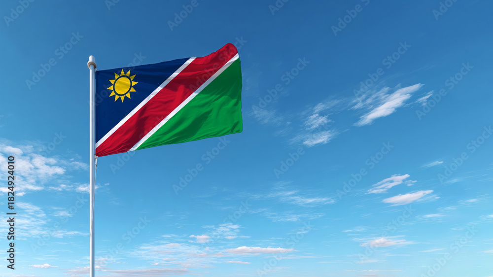 Naklejka premium Celebration of Independence Day with the Namibian flag waving in a clear blue sky