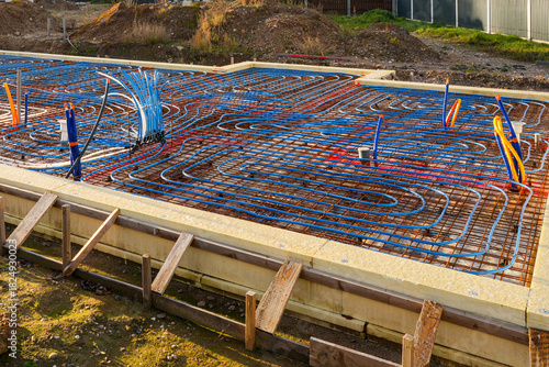 Underfloor heating installation with pipes and rebar grid prepared for concrete foundation