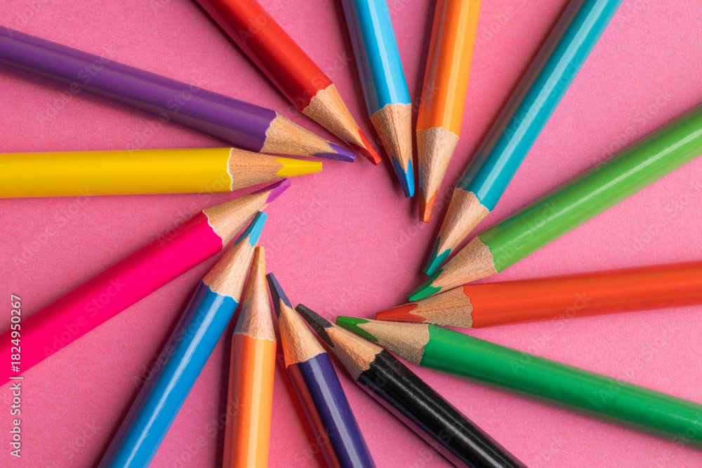 Fototapeta premium colored pencils on a pink background