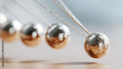 Newton's cradle with swinging balls demonstrating physics principles  