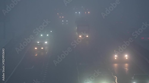 poor visibility on the road. cars are moving slowly along the highway.