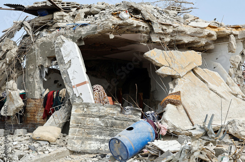 Ruins of a collapsed building with debris and rubble creating a cave like opening