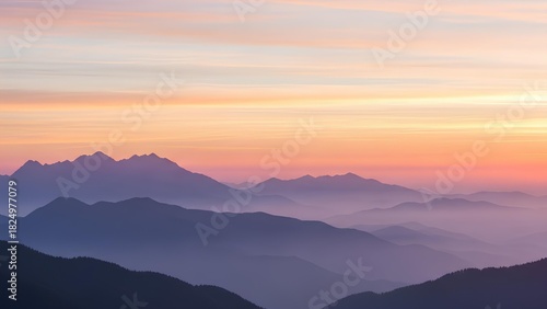 Wallpaper Mural Serene mountain range shrouded in mist at sunrise with soft pastel sky Torontodigital.ca