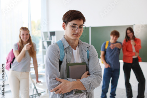 фотографія Students bullying their classmate in classroom, selective focus