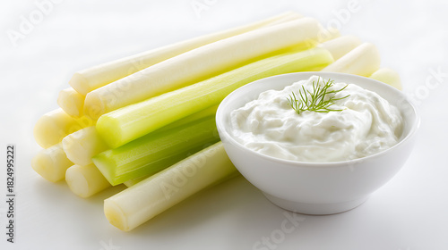 Vegetable sticks with plain Greek yogurt in a white bowl