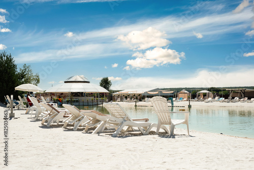Wallpaper Mural Recreation complex with sun loungers and a covered tent with a pond Torontodigital.ca