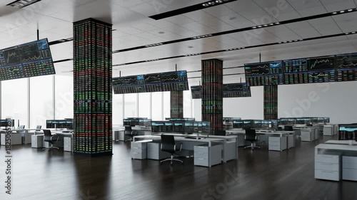 Modern trading floor with desks, screens displaying data, and large grid-like displays on pillars