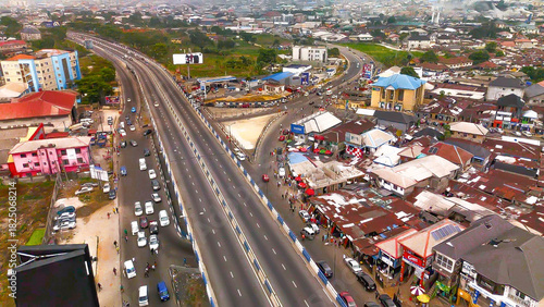 Aerial view of Garrison Junction's vibrant interchange, where cars stream along the highway amidst the bustling market, Port Harcourt, Rivers State, Nigeria.