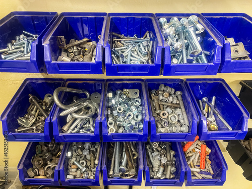 shelves with various bolts and screws for repairs in the workshop
