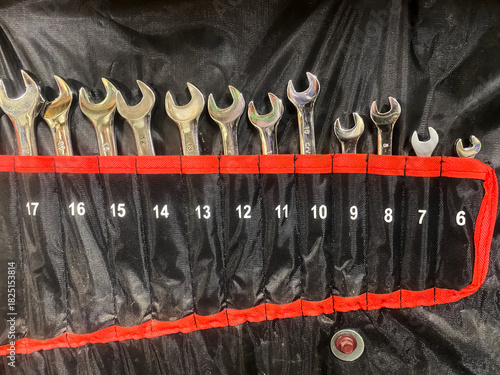 A close-up of wrenches of different sizes arranged in an organizer