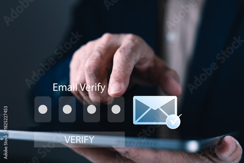 Tableau sur toile Businessman tapping tablet to verify email with code, showing secure login proce