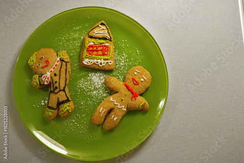 Decorated gingerbread men on a green plate