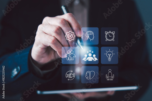 Hand pointing digital interface icons for teamwork, leadership, innovation, collaboration, and soft skills development concept on modern technology