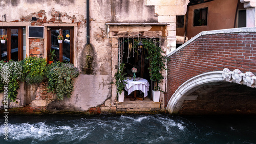 Classic Venice scenery featuring canals, boats, bridges and timeless Italian architecture in a peaceful, picturesque setting.