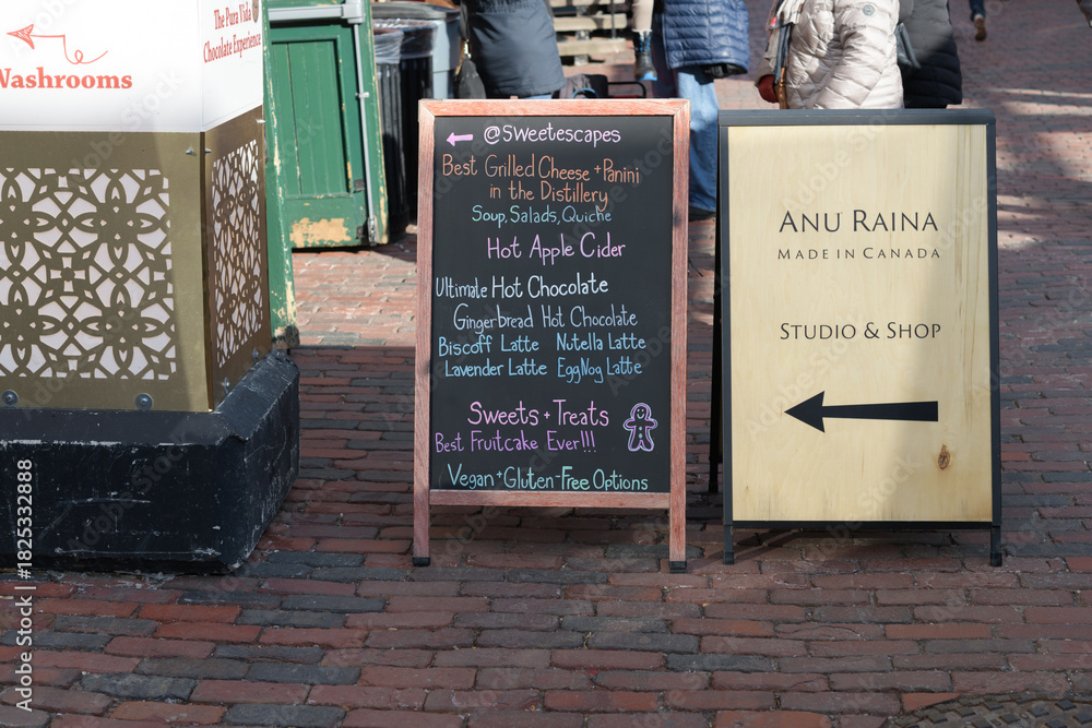 Fototapeta premium sidewalk signs for The Sweet Escape and Anu Raina located at 24 Tank House Lane, Distillery District, Toronto