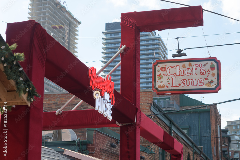 Fototapeta premium Chef's Lane (Naughty or Nice) at The Distillery Winter Village 2025, 55 Mill St, The Distillery Historic District, Toronto