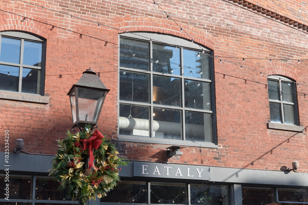 Fototapeta premium exterior building facade and sign of Eataly located at 21 Trinity St, The Distillery Historic District, Toronto