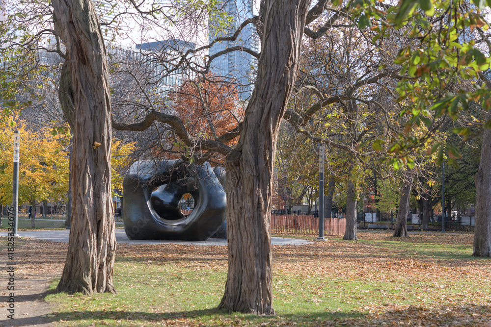 Fototapeta premium through the trees view of Henry Moore's Large Two Forms, western edge of Grange Park, Toronto