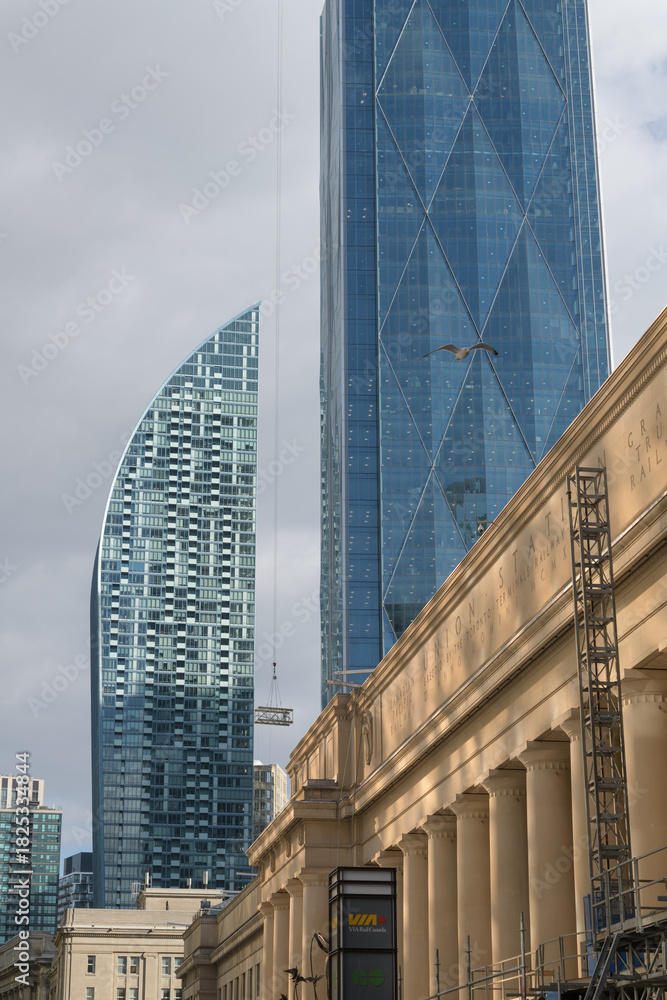 Fototapeta premium contrast of architecture: L-Tower condominium complex, CIBC Square, and Union Station, Toronto
