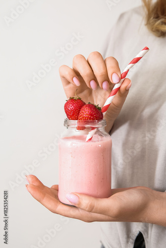 Woman holding mason jar of ...