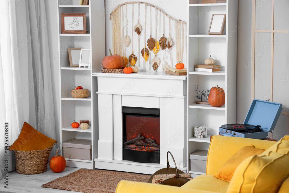 Fototapeta premium Interior of living room with pumpkins, fireplace and shelf units