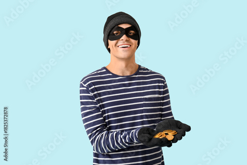 Male thief with golden coin...