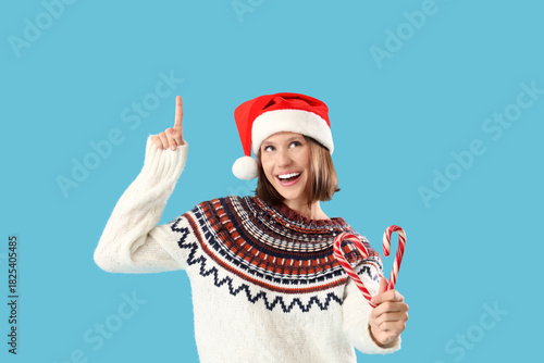 Young woman in Santa hat wi...