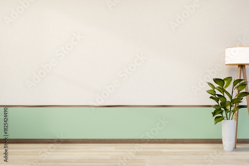 Fototapeta Naklejka Na Ścianę i Meble -  High floor standing lamp and plant in ceramic pot on wooden parquet floor aside white and green wall