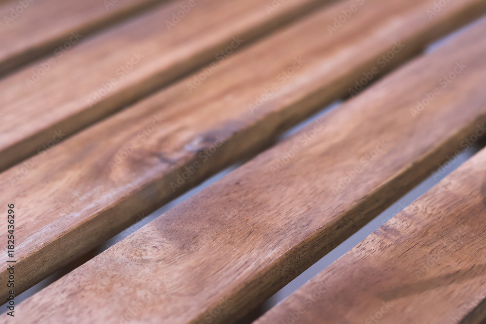 Fototapeta premium Warm brown wood plank background with natural texture and grain. simple, calming parallel board pattern works well for flooring, decking or furniture design concepts