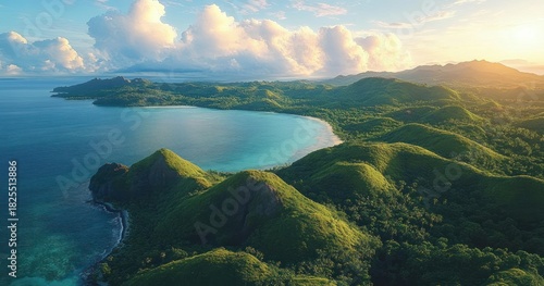 Aerial view of rolling green hills and turquoise bay with sandy beach under a dramatic cloud-filled golden sky, evoking tranquil awe