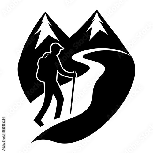 Silhouette of a hiker walking on a mountain path with snow capped peaks