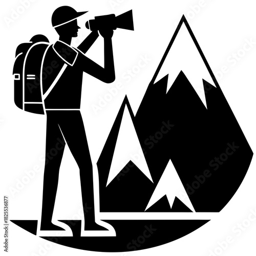 Hiker with backpack looking through binoculars at mountains