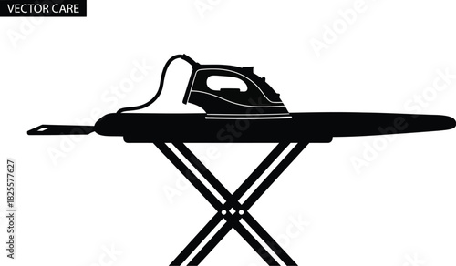 Black iron on ironing board, laundry appliance for clothing care