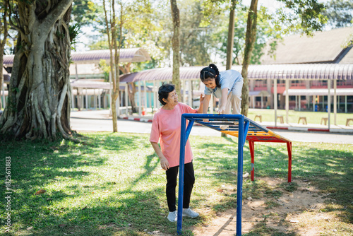 Joyful interaction between parent and child in a vibrant playground setting, capturing laughter and playfulness under the sun-dappled trees
