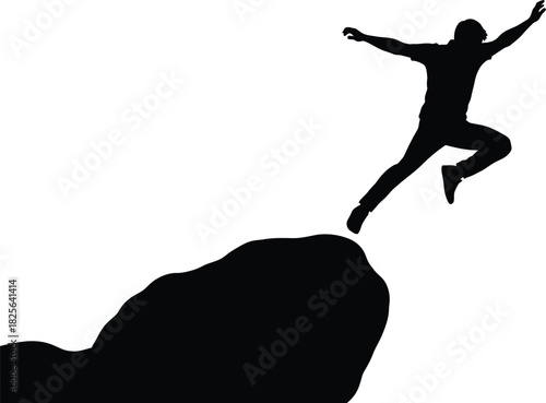 Silhouette of a person jumping off a rocky cliff