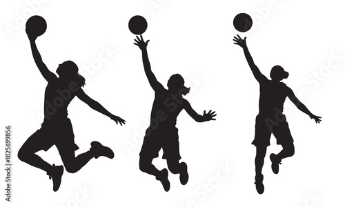 Three basketball players in mid air silhouette for a slam dunk