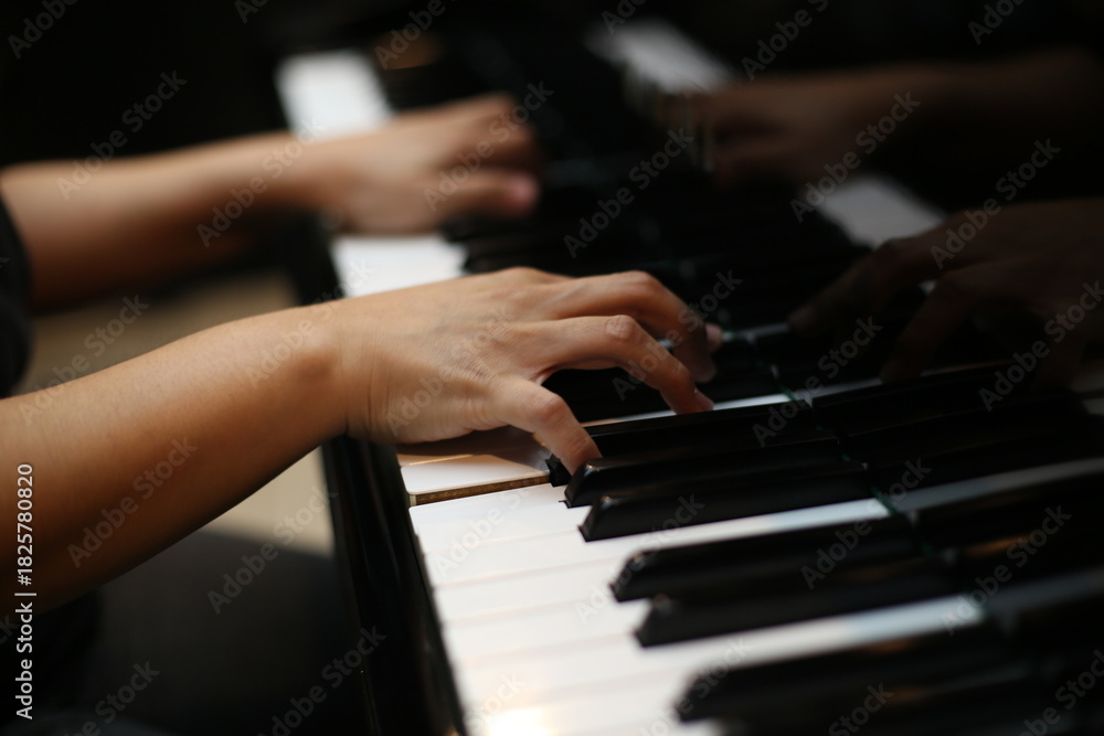 Obraz premium Hands Playing Piano Keys Close Up