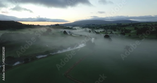 Dawn in a misty valley