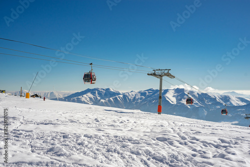 Gudauri Ski Resort: Gondola (Ski Lift) and Snow-covered Caucasus Mountains in Distance - Gudauri, Georgia.