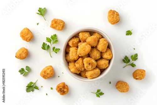 Crispy Chicken Popcorn Bites in Ceramic Bowl with Fresh Parsley on White Background