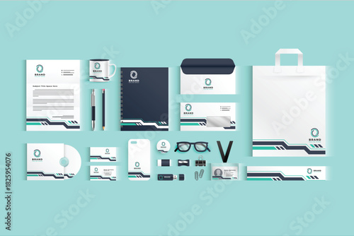 Arranged corporate branding items stationery notebook mug phone case USB glasses bag badge envelope on a light blue background