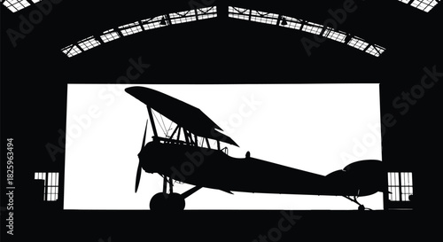 Silhouette of a vintage biplane in a hangar with backlighting 