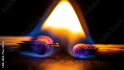 Burning matches with flames against a dark backdrop